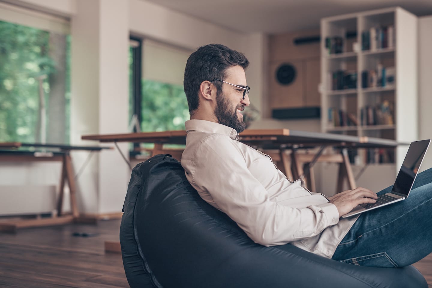 smiling-man-with-laptop-indoors-B3U679G