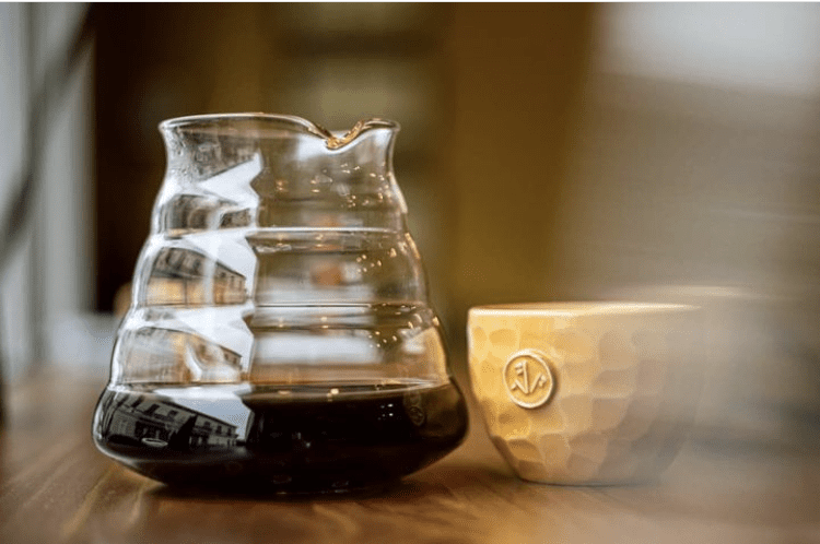 V60 glass and cup of coffee