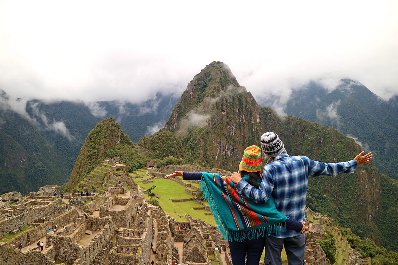 Couple admiring the spectacular view of Machu Picchu, UNESCO Wor